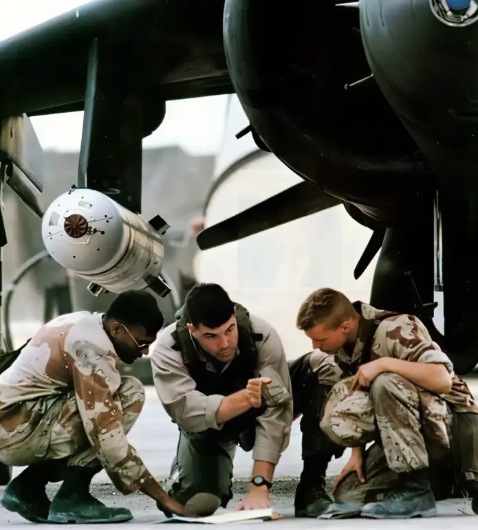 The Harrier Association Three soldiers in uniform kneel under a military aircraft, examining a map and discussing plans.